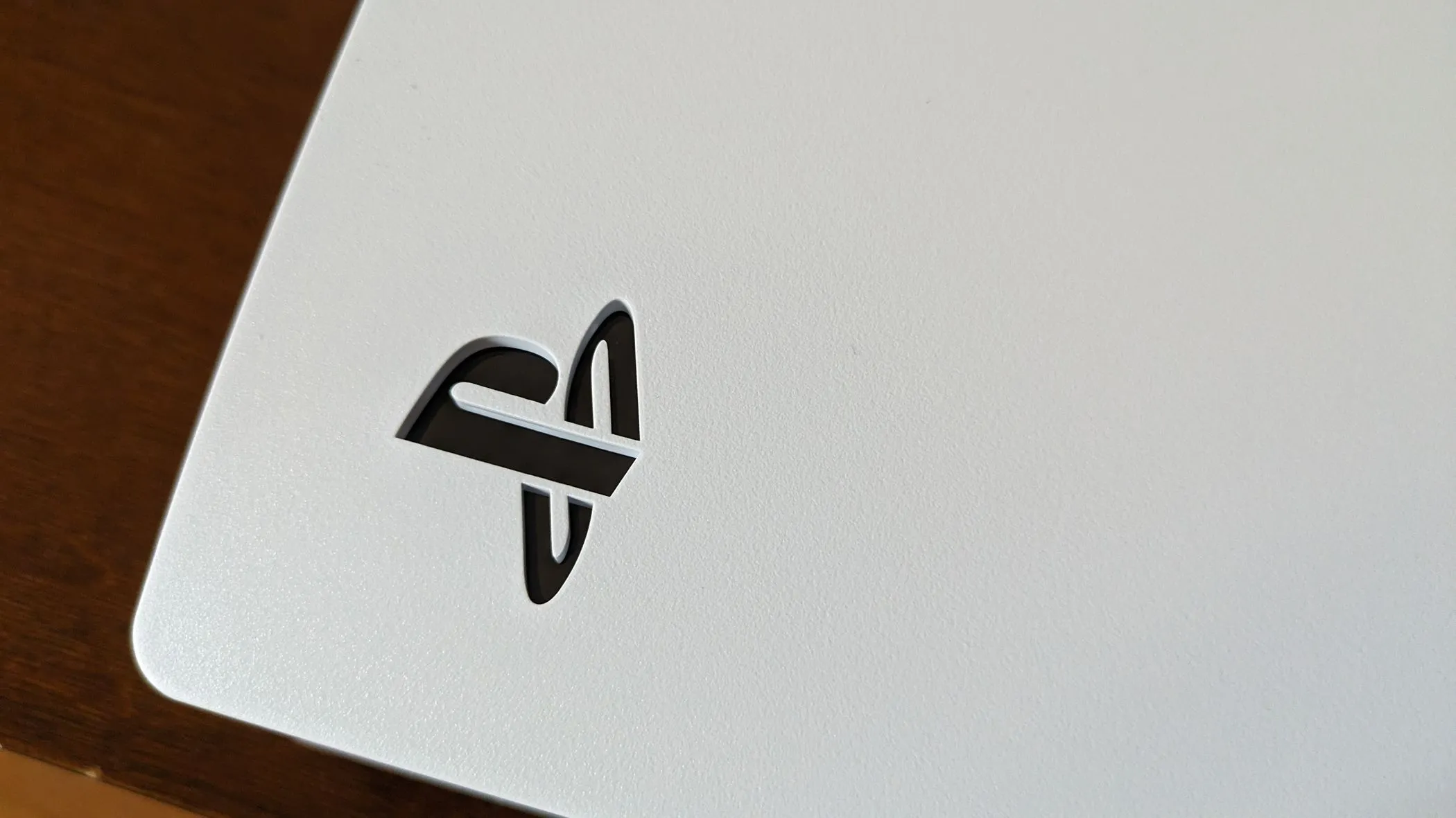Biểu tượng PS5 nổi bật trên thân máy PlayStation 5, thể hiện thương hiệu của console đối thủ cạnh tranh chính của Xbox.