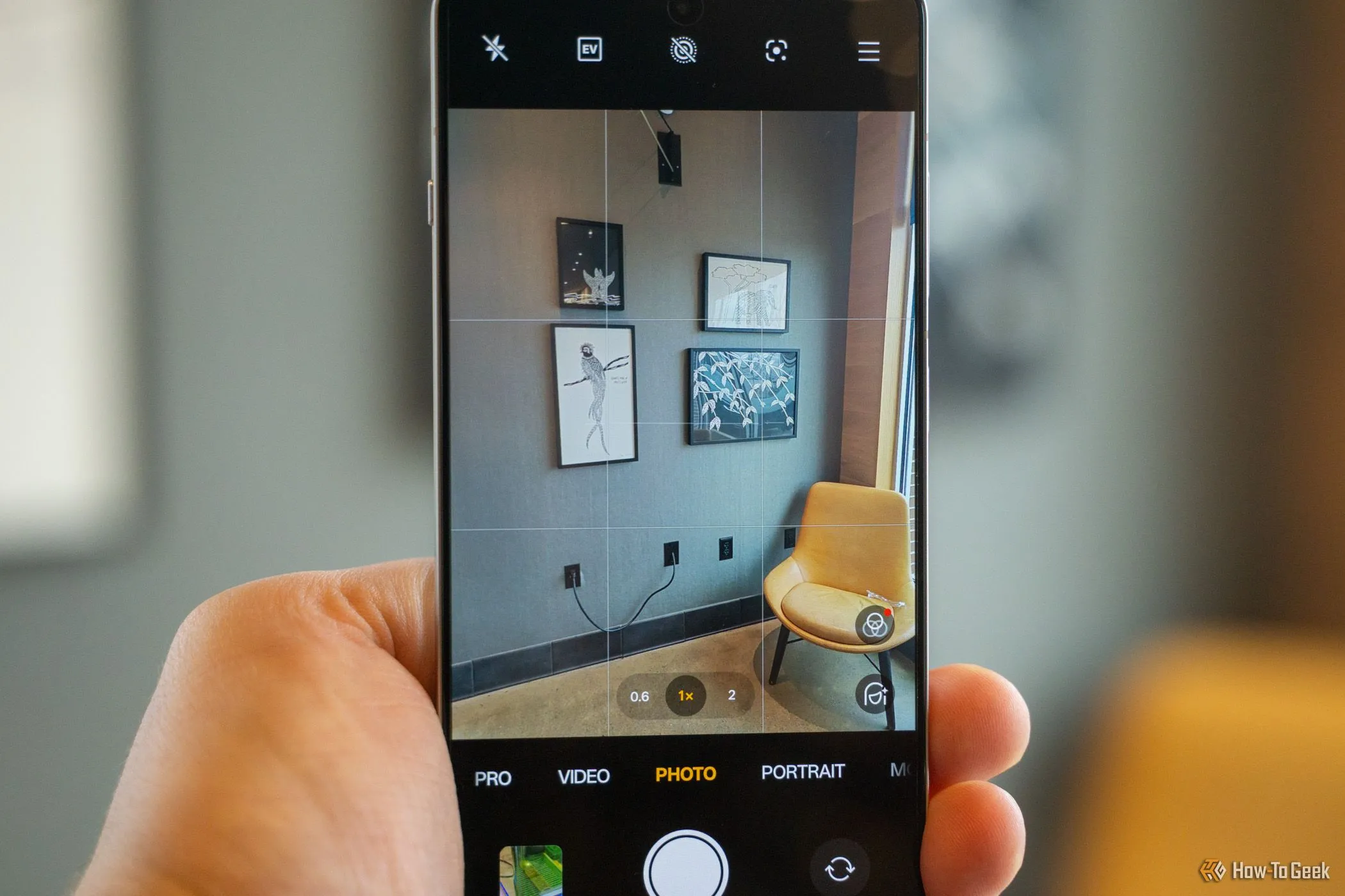 Ứng dụng camera của OnePlus 13R đang hướng vào một bức tường với nhiều ảnh.