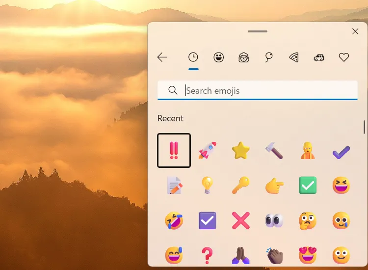 Bảng chọn biểu tượng cảm xúc (emoji panel) trong Windows 11, minh họa cách chèn emoji nhanh bằng Win+Dấu chấm.