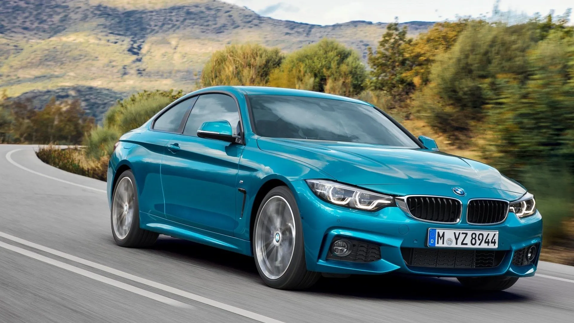 BMW 4-Series Coupe 2018 màu bạc đang di chuyển trên đường, thể hiện vẻ ngoài năng động và khả năng vận hành linh hoạt của dòng xe thể thao sang trọng