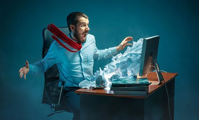 Hình minh họa một người đàn ông phản ứng với thư rác trên màn hình máy tính của mình, tượng trưng cho sự phiền toái và nguy hiểm của email rác.