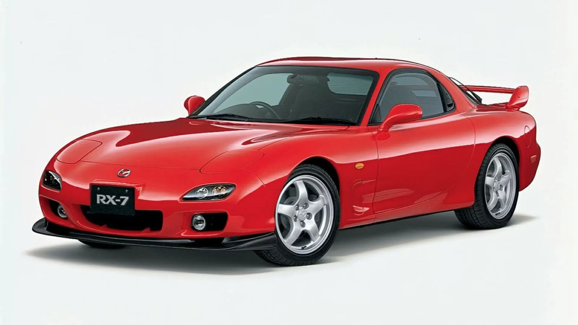 Mazda RX-7 2001 màu đỏ nổi bật trong studio, một biểu tượng xe thể thao động cơ rotary với thiết kế vượt thời gian.