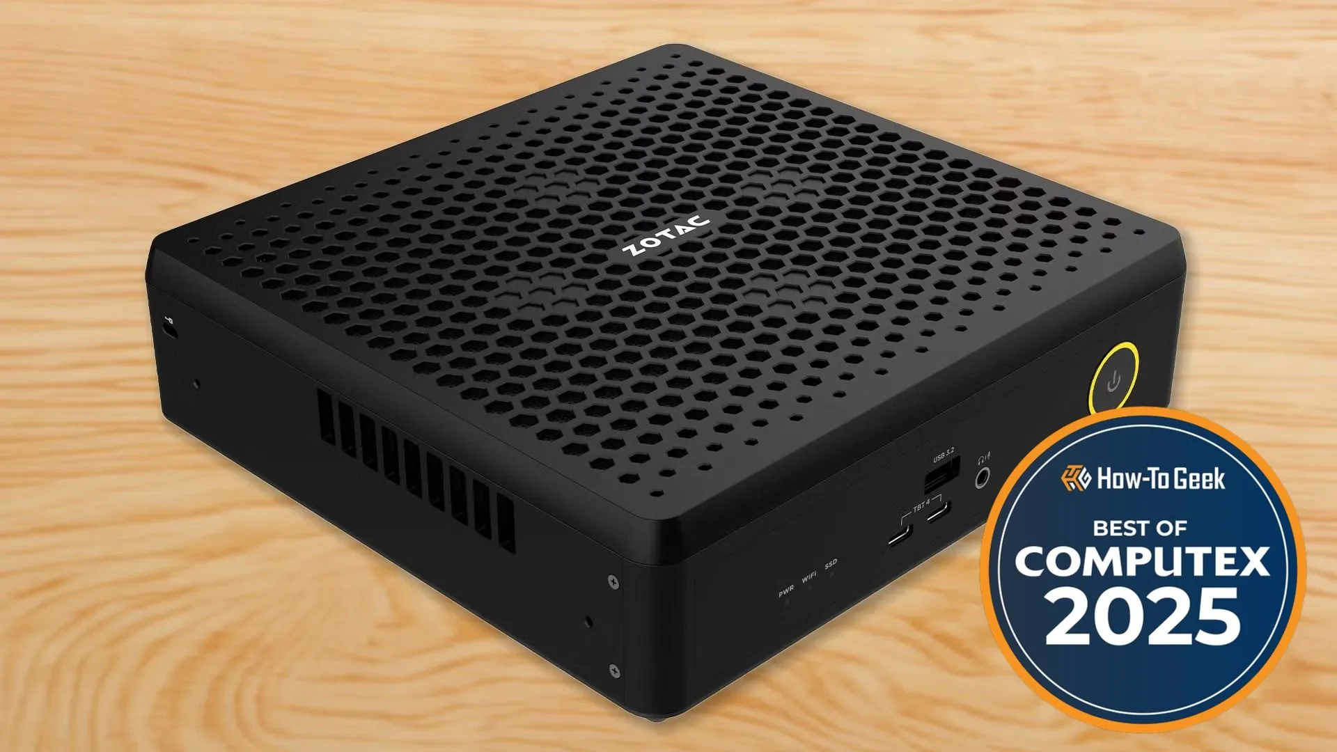 Mini PC Zotac Magnus EN75060TC màu đen đặt trên nền gỗ, thể hiện thiết kế nhỏ gọn nhưng mạnh mẽ với hiệu suất cao.