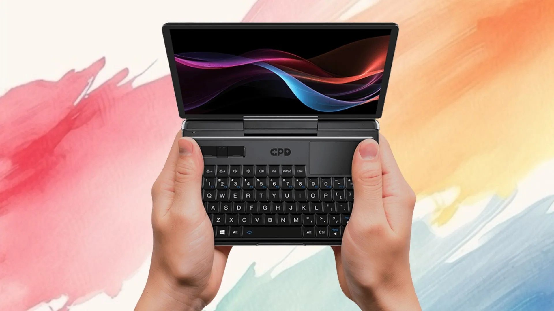 Một người đang sử dụng GPD Micro PC 2 cầm tay trên nền màu, bàn phím và màn hình nhỏ hiển thị rõ