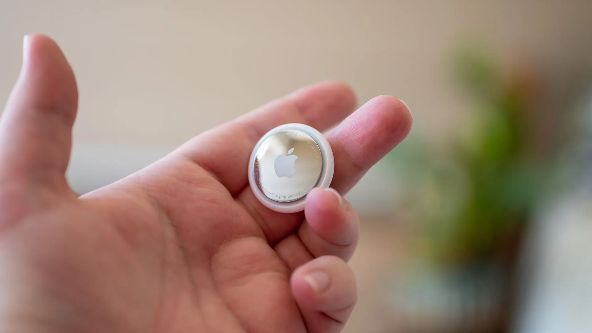 Người dùng cầm AirTag, thiết bị theo dõi vật phẩm cá nhân tiện lợi của Apple