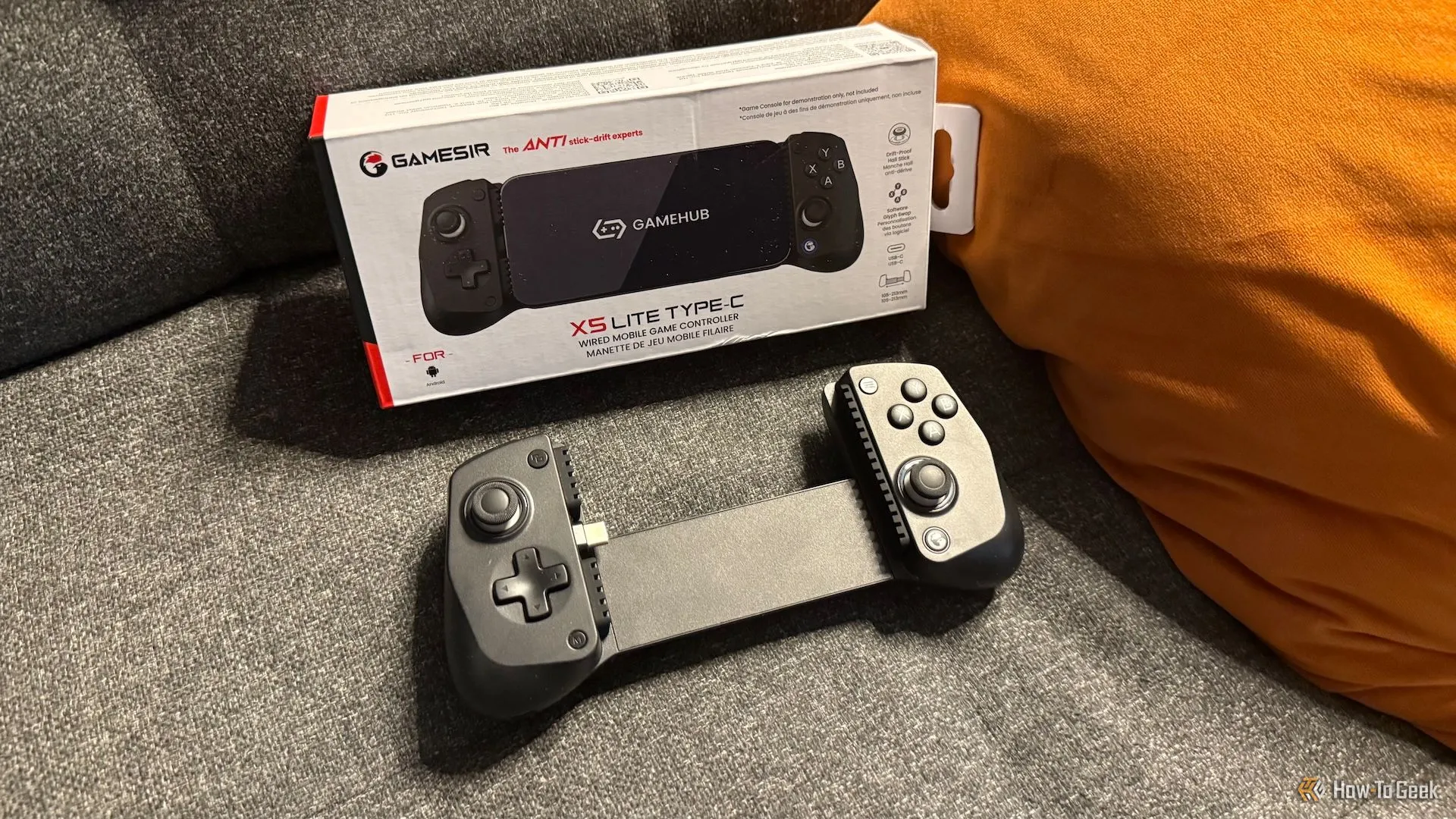 Tay cầm GameSir X5 Lite và hộp đựng sản phẩm đặt trên ghế sofa, gợi ý sự tiện lợi và tính di động của sản phẩm.