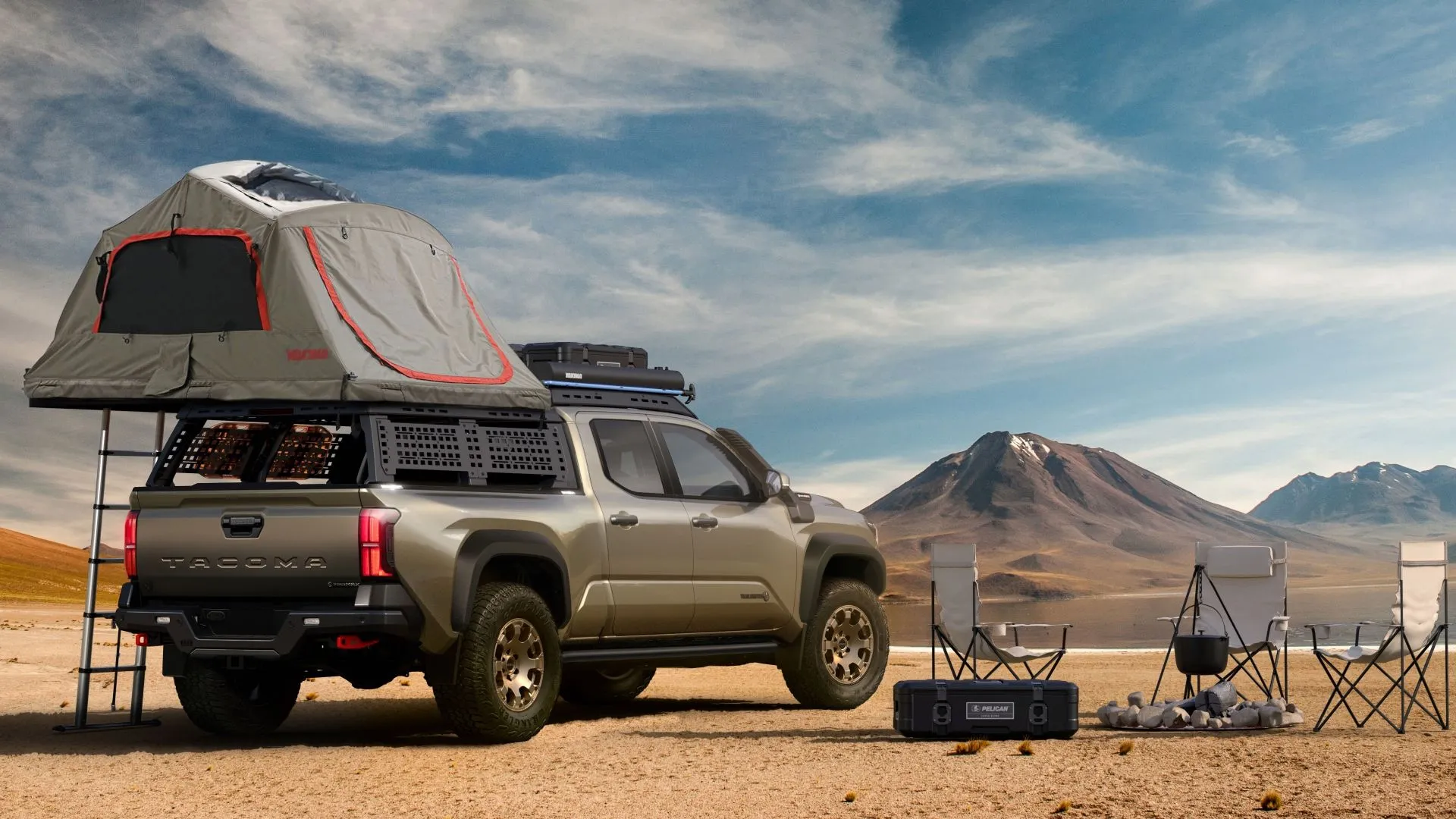 Toyota Tacoma 2025 Trailhunter màu xám tại bãi cắm trại, minh họa phiên bản hybrid mạnh mẽ